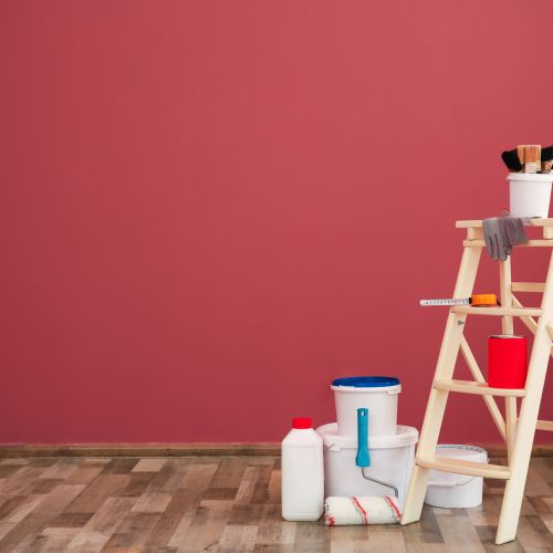 Step ladder and decorator's tools near color wall
